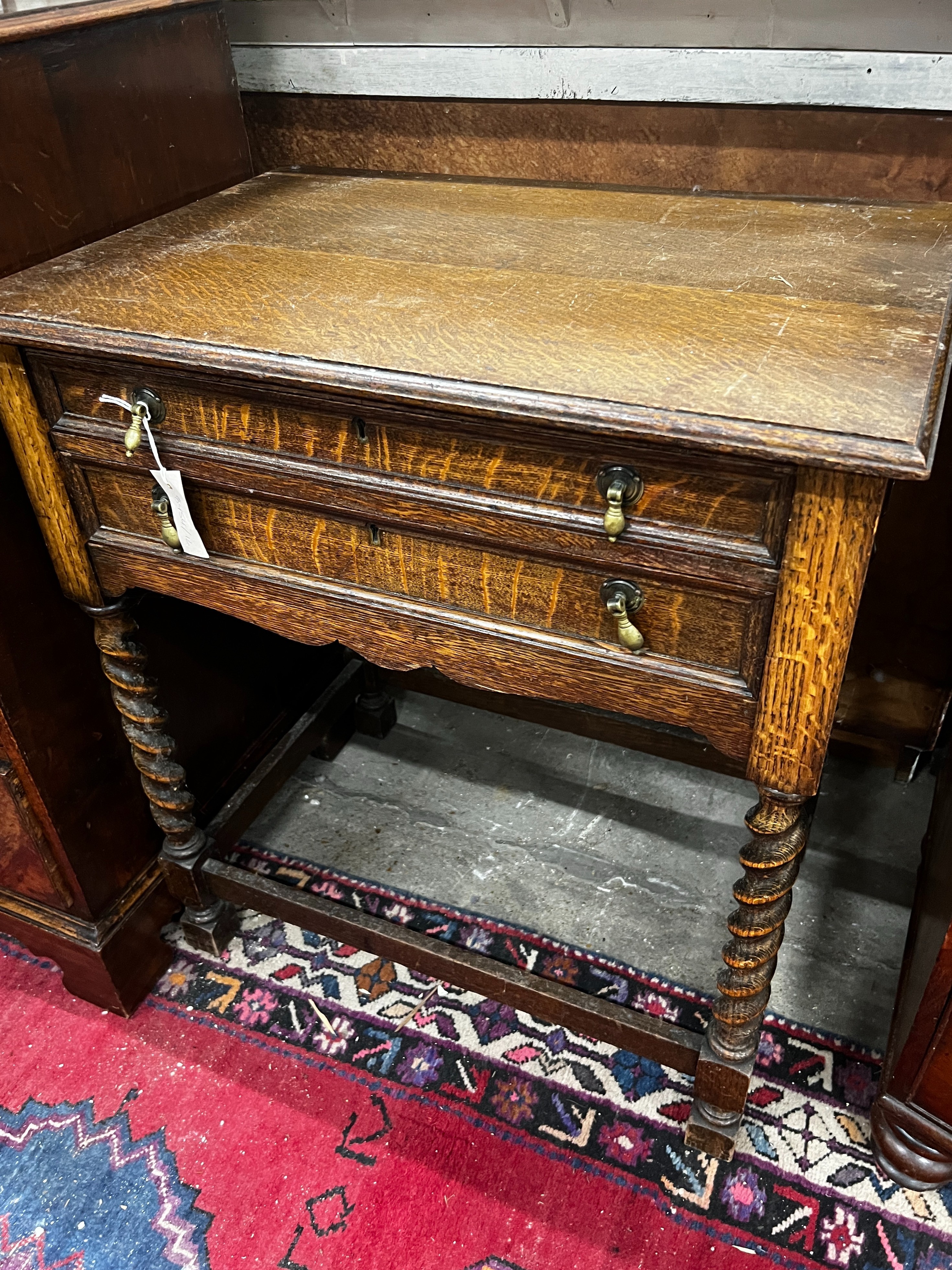 A part canteen of Walker & Hall silver plated Old English pattern cutlery, contained in an oak standing two drawer chest, width 68cm, depth 47cm, height 77cm